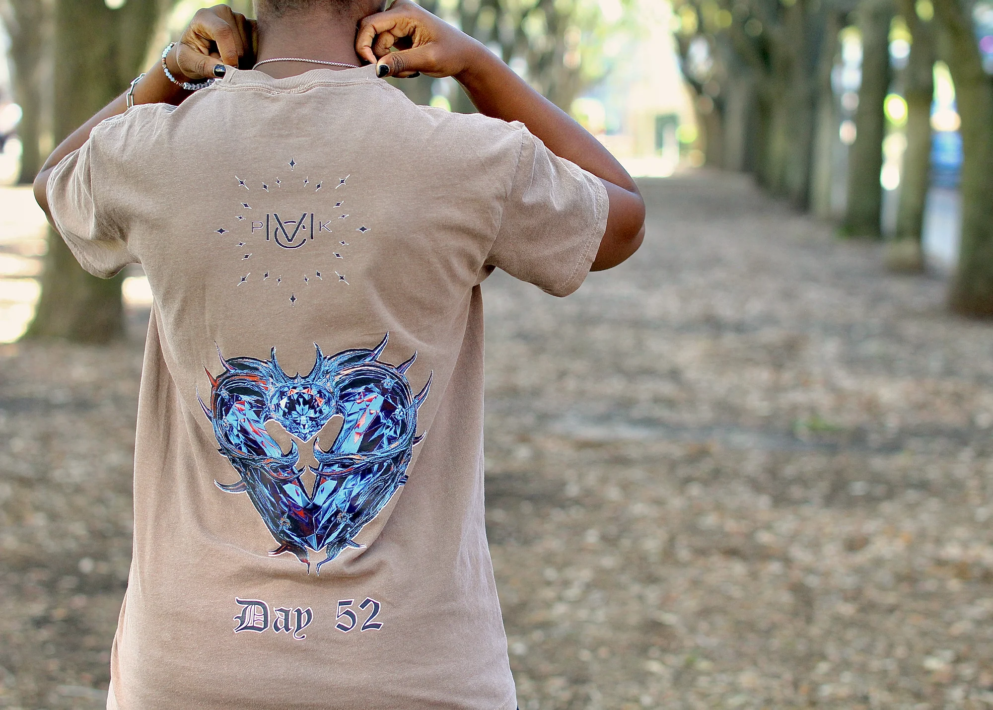 Back of the Day 52 tee on a tree lined path in soft daylight